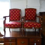 A pair of Empire style mahogany open armchairs, with musical motif red upholstery