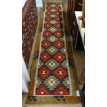 A Mamainer red ground Kilim runner, 390cm x 84cm