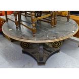 A large circular painted and gilded dining table, on scrolled platform base