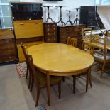 A mid-century teak dining room suite, comprising an oval extending table with 4 matching chairs, and