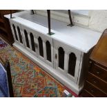 A low painted cabinet, with 4 arch-top mesh panelled doors, on plinth base, L200cm, H75cm, D52cm