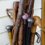A large collection of walking sticks and canes, including example with rhodonite knop and silver