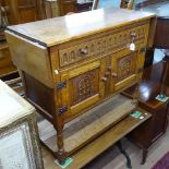 An Ipswich joined oak side cabinet with drop flaps, single frieze drawer, cupboards under, and pot