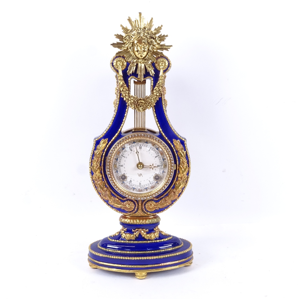 A blue and gilt decorated clock from the Victoria & Albert museum, height 38.5cm, with 2-train