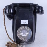 A black Bakelite dial wall telephone