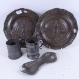 A pair of Continental eagle decorated pewter wall plaques, 29cm, a pewter tankard, jug and snuffer