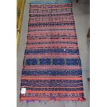 A red ground Kilim rug, 145cm x 65cm