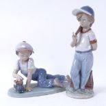 A Lladro porcelain boy with toy train, model no. 7619, signed, and a Lladro boy with baseball, model