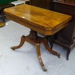 A Regency mahogany and ebony-strung fold over card table, on a turned centre column, and raised