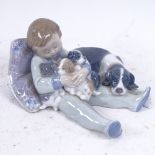 A Lladro porcelain group, boy with dogs, model no. 1535, length 17cm