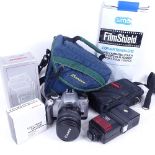 A Canon Eos 300 35mm camera with Cobra flash, lens hood etc