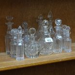 A group of small cut-glass scent bottles and decanters, including mallet-shaped example