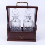 A Vintage oak 2-bottle tantalus, with 2 Stuart Crystal cut-glass decanters and stoppers, tantalus