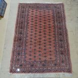 A salmon ground Tekke design rug, 180cm x 130cm