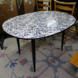 A mid-century formica dining table, with black and white floral design top and ebonised legs,