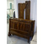 A Continental panelled walnut single bed