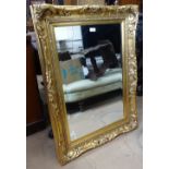 A modern gilt-framed bevel-edge wall mirror, 71cm x 98cm