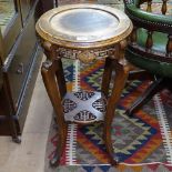 An Oriental jardiniere stand, with a carved and pierced frieze and under-tier, on cabriole legs,
