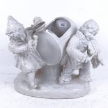 A Continental white glaze porcelain table centre jardiniere, in the form of 2 children playing