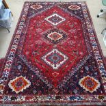 A red ground Afghan design carpet, with geometric pattern, 220cm x 115cm