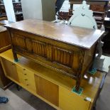 A 1920s oak coffer with linenfold panelled front, on style legs, W106cm, H51cm, D45cm