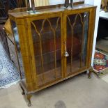 A 1930s walnut display cabinet with 2 lattice-glazed doors, W109cm, H115cm, D30cm