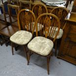 A set of 4 oak wheel-back dining chairs