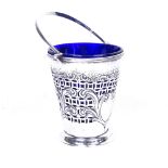 A Victorian silver swing-handled bucket, with pierced and embossed scrolled decoration, and blue