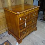 A small reproduction yew wood chest, with brushing slide, 2 short and 2 long drawers, on bracket