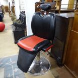 A red and black rexine-upholstered barber's chair, on chrome adjustable stand