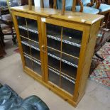 An Antique pine bookcase with 2 lattice-glazed doors, W126cm, H126cm, D35cm