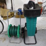 A Bosch garden shredder, hose reel, and a Kamsa bench vice