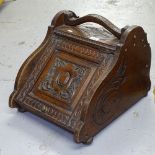 A Victorian carved oak coal box