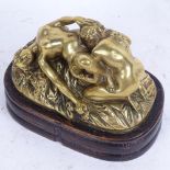 A polished bronze erotic sculpture on wood plinth, length 14cm