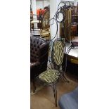 A large Andre Dubreuil style elaborate wrought-iron wirework chair, with mounted glass lens, circa