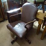 An early 20th century studded upholstered swivel desk chair, on splayed leg base