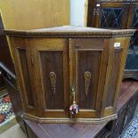 A small panelled oak 2-door hanging corner cupboard, W72cm, H66cm