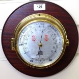 A Sewills brass barometer on oak plaque, diameter 28cm