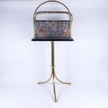 An early 20th century brass and copper tripod swivel magazine rack, height 84cm