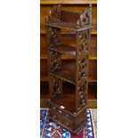 A narrow reproduction mahogany hanging open shelves, with lattice sides and 2 short drawers,