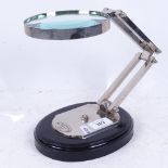 A reproduction nickel plate desktop magnifying glass, on wood plinth, lens diameter 12.5cm