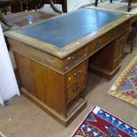 An Edwardian oak twin-pedestal writing desk, W121cm, H75cm, D71cm