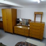 A mid-century teak 4-piece bedroom suite, to include a 2-door wardrobe, dressing table chest and