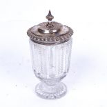 A 19th century cut-glass salt with embossed silver mount and lid