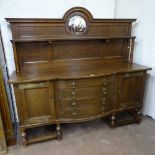 An early 20th century oak sideboard, with raised shelf and panelled mirror-back, 4 bow-fronted