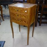 A walnut and marquetry decorated Continental bedside chest, with 3 short drawers, on tapered legs,