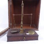 A set of 19th century brass jeweller's balance scales, on mahogany drawer-fitted base, in mahogany