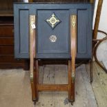 A Slade Brothers portfolio stand, on a hinged stand, leather-covered and stylised brass mounts,