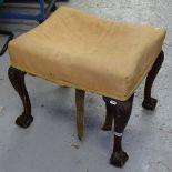 A 19th century upholstered footstool, on shell carved cabriole legs, with claw and ball feet, W60cm,