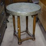 An Austrian secessionist side or lamp table, on oak base, with Orientalist engraved brass top,